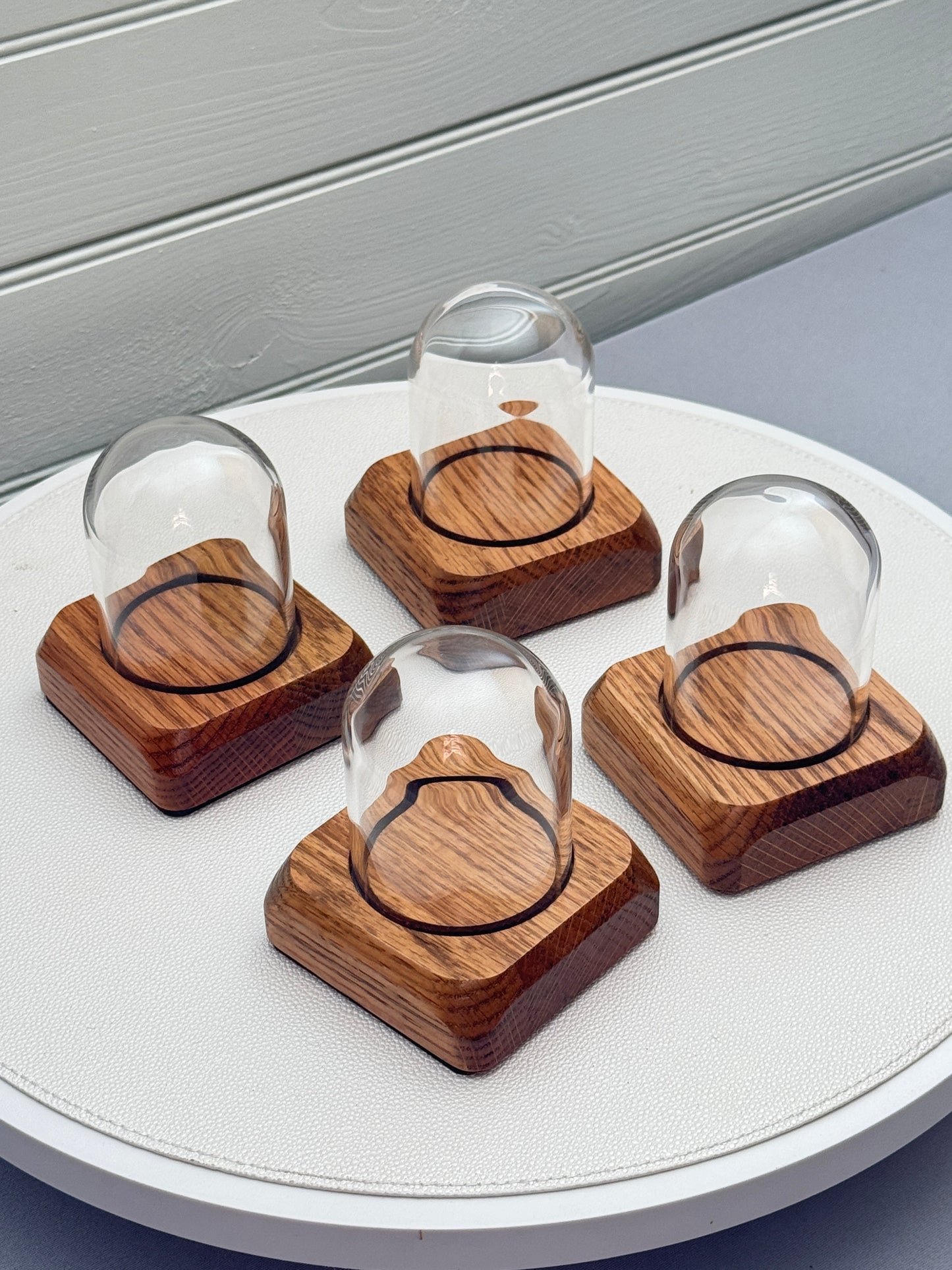 Four small Oak Displays with glass domes