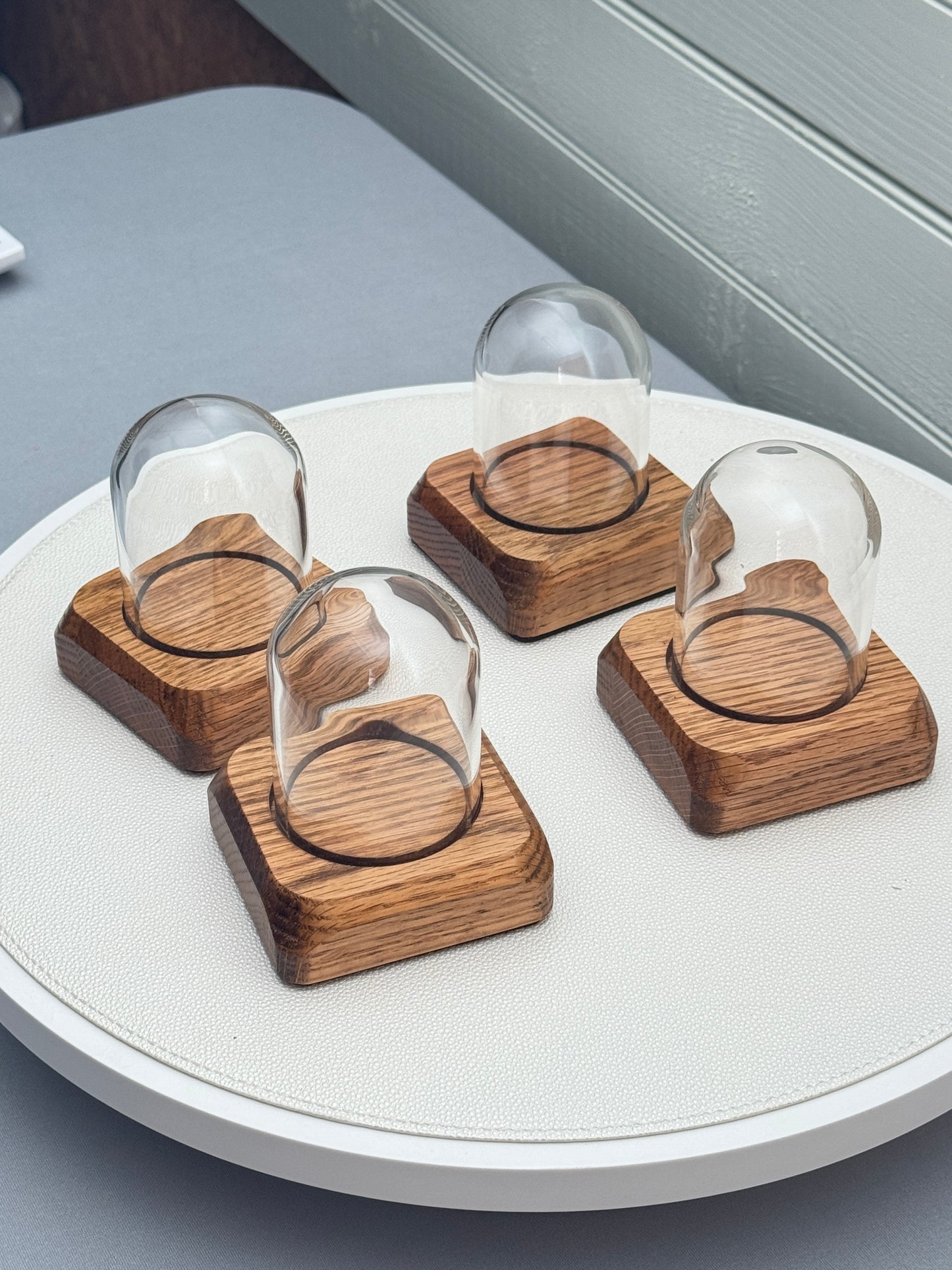 Four small Oak Displays with glass domes