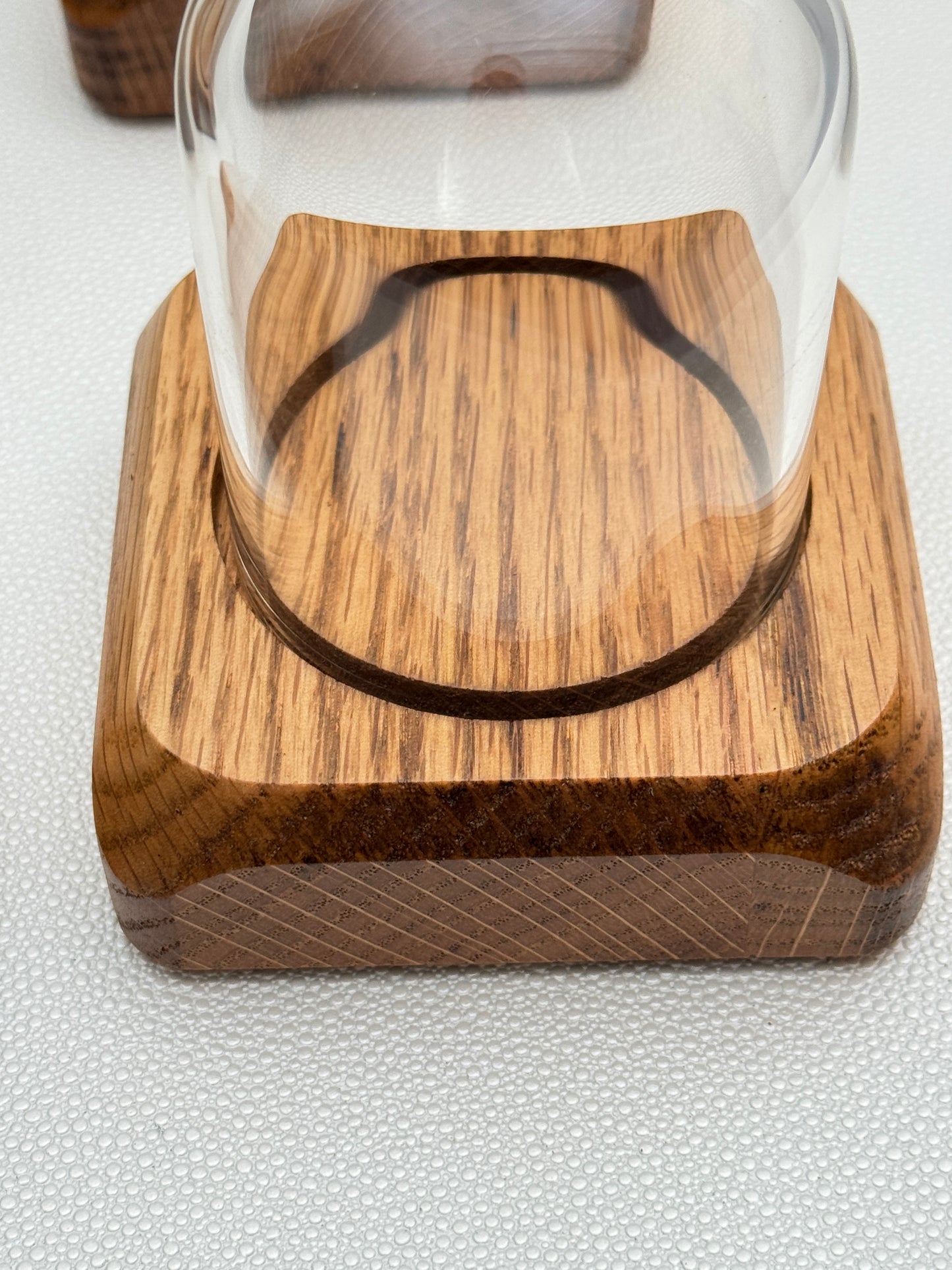 Four small Oak Displays with glass domes