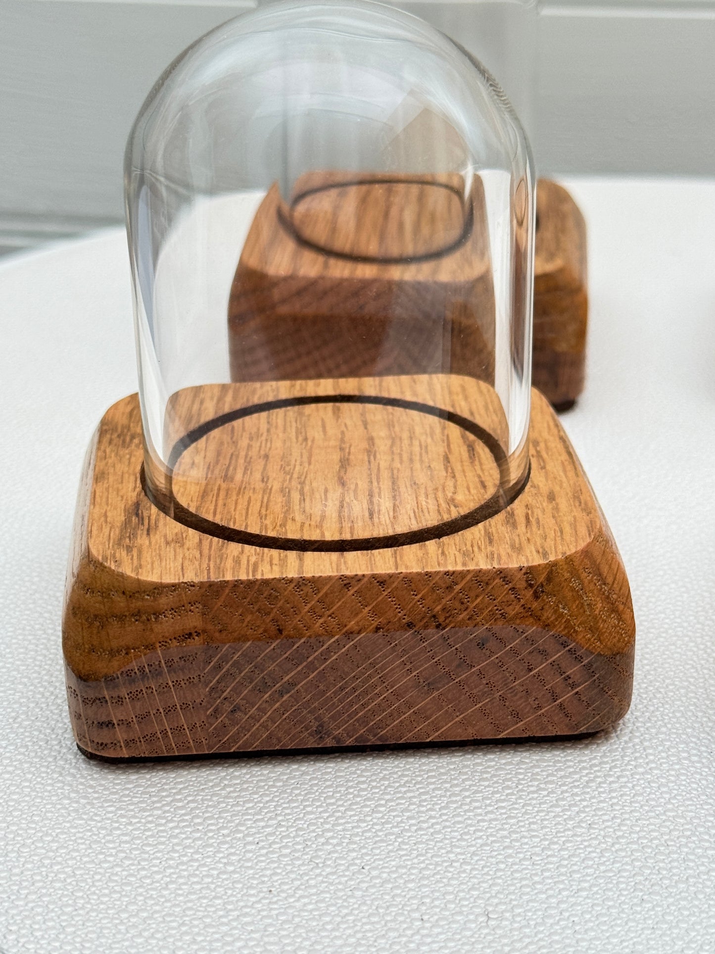 Four small Oak Displays with glass domes