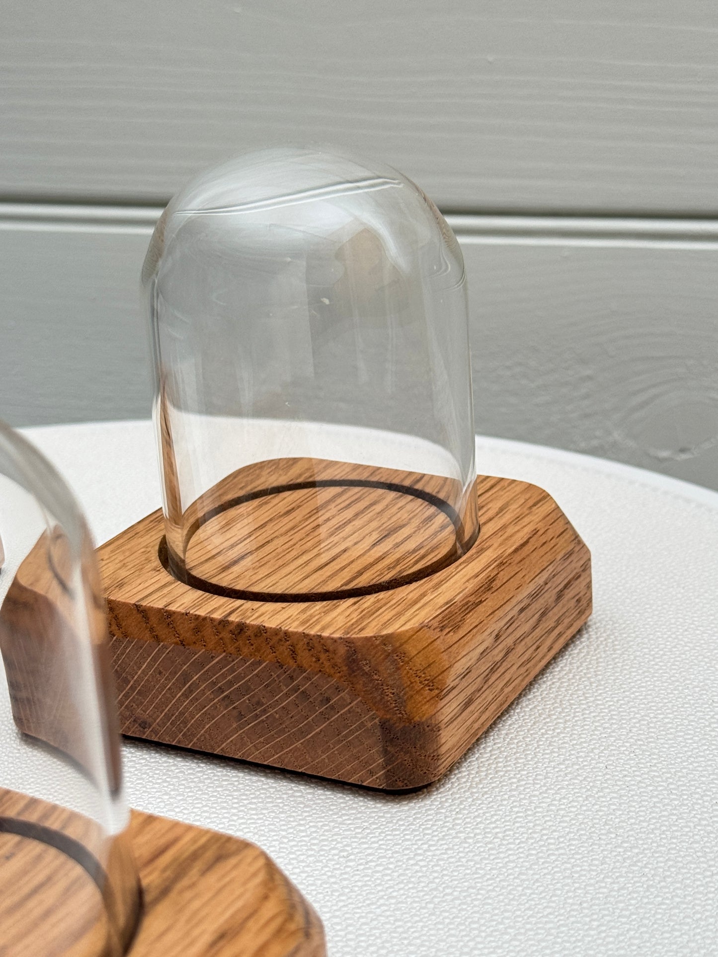 Four small Oak Displays with glass domes