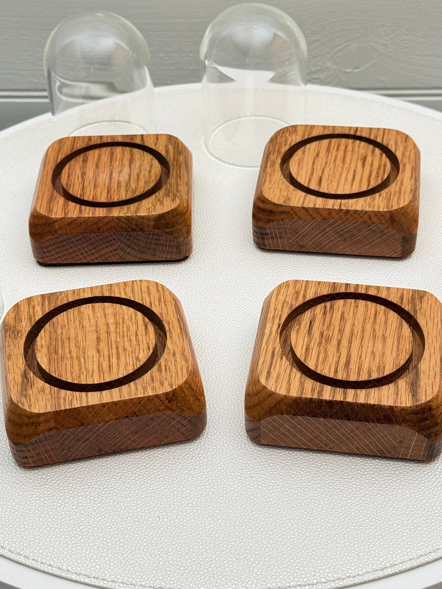 Four small Oak Displays with glass domes